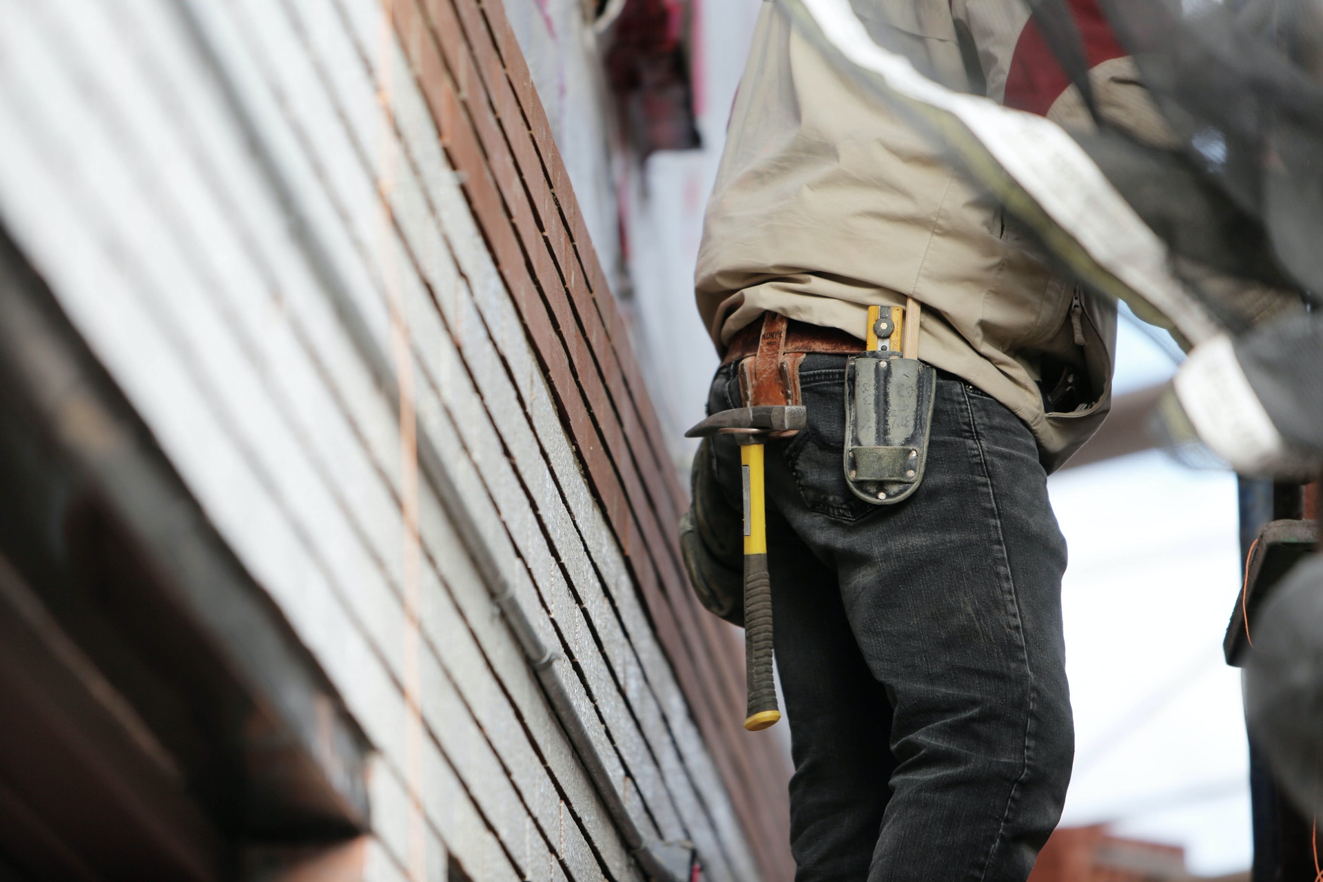 repair man standing near a house