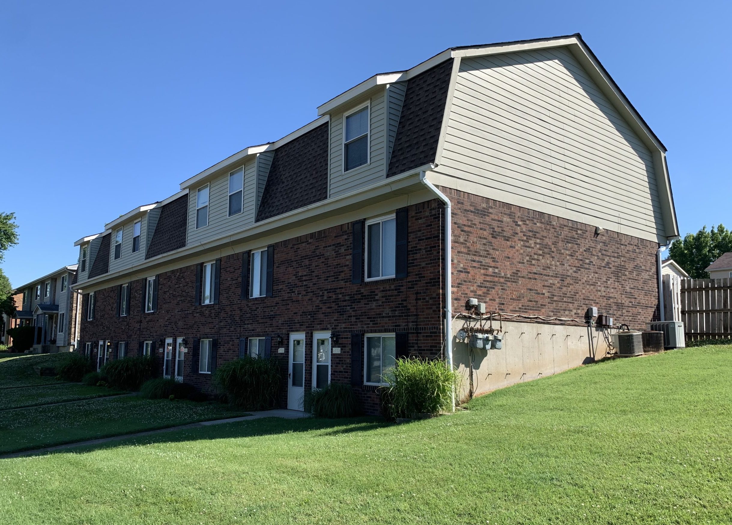 View of a brick housing complex and yard